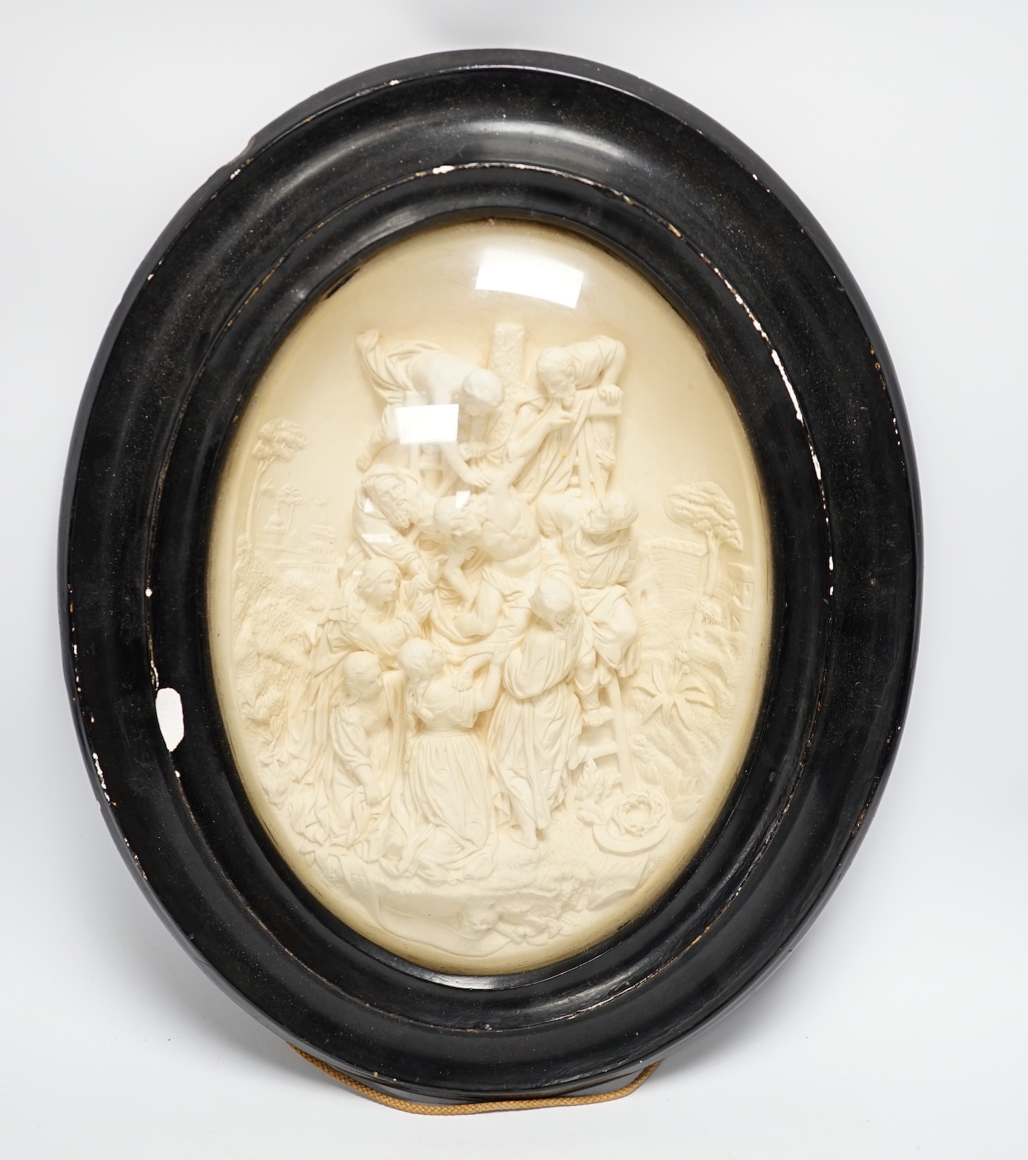 A pair of framed plaster ovals of the Madonna and Child with John the Baptist and the 'Descent from the Cross' 41x33cm